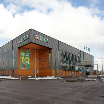 A windowless hypermarket with a big street intersection in front of it