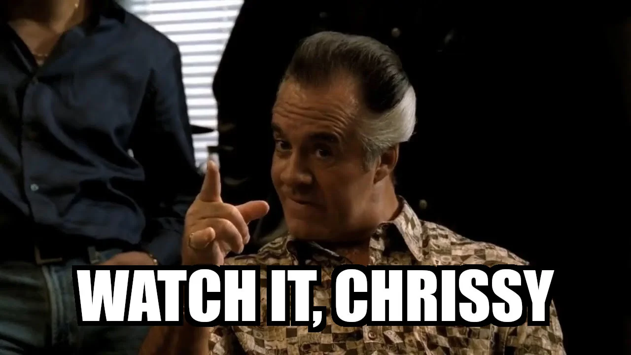 A still image of the character Paulie Walnuts in the TV series The Sopranos. The caption says "watch it, Chrissy" which is what Paulie says in this scene.