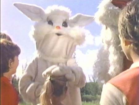 Screenshot of the Ice Cream Bunny, a horrid-looking bunny mascot costume character made of loose wrinkly fabric, from the film "Santa and the Ice Cream Bunny."