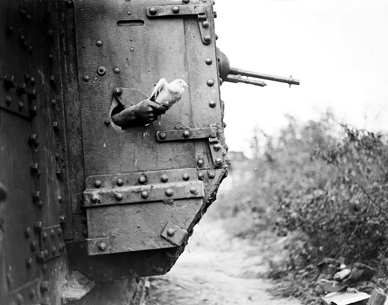 A tank with a pigeon being released from a hatch.