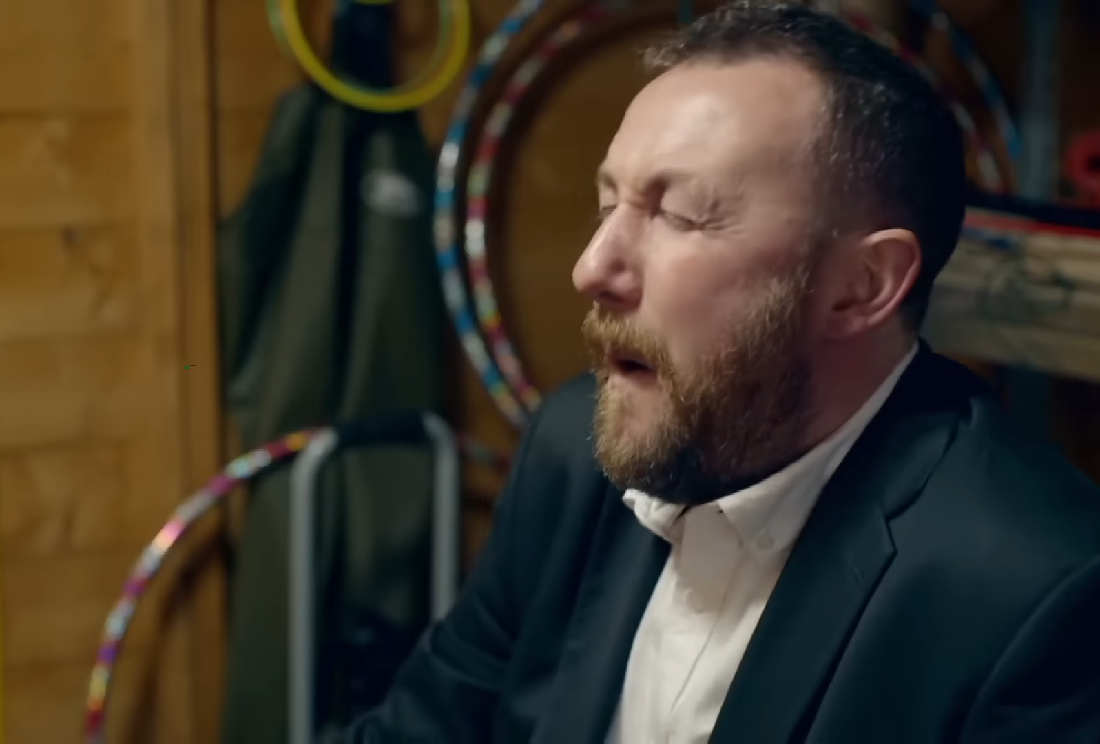 Alex Horne from Taskmaster, sitting on a cream cake with his bare backside